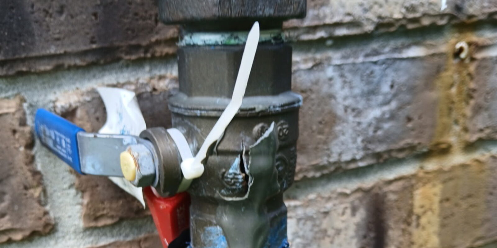 A worn above-ground assembly on a Katy irrigation system — the freeze-prone part to protect before a hard freeze